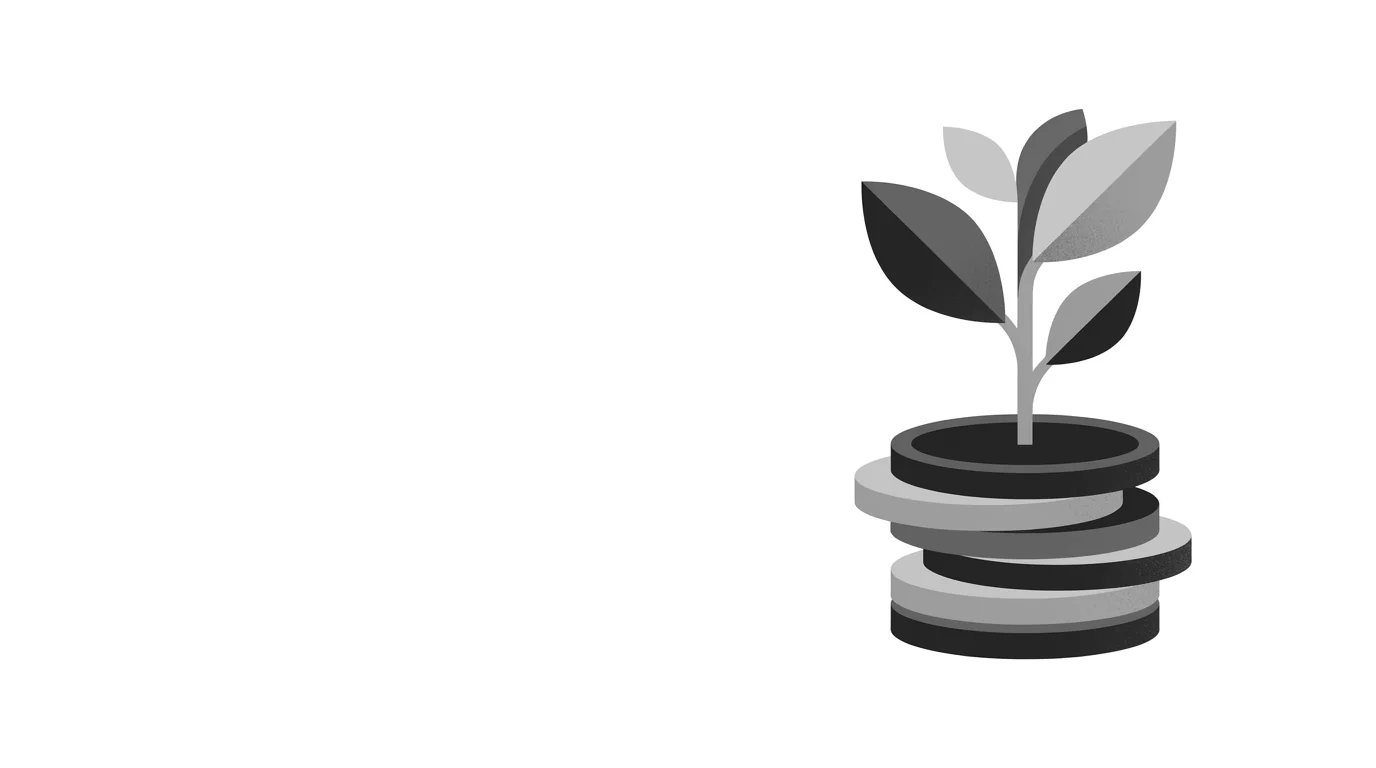 A sapling growing from a stack of coins
